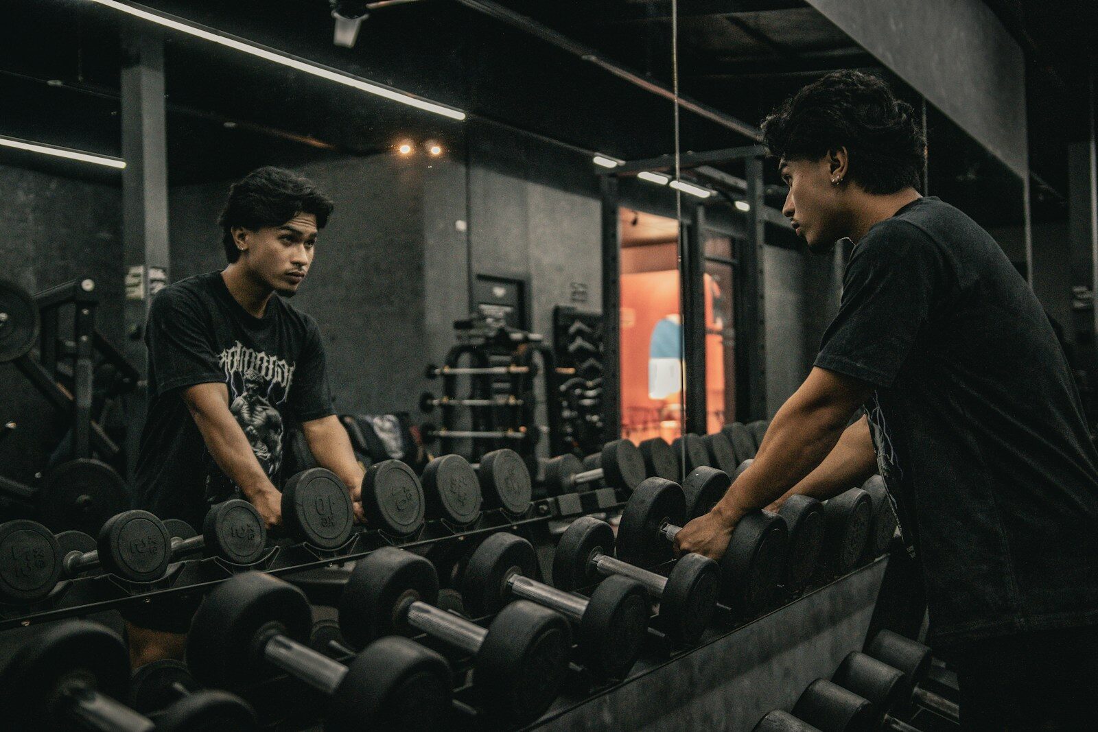 A couple of men working out in a gym