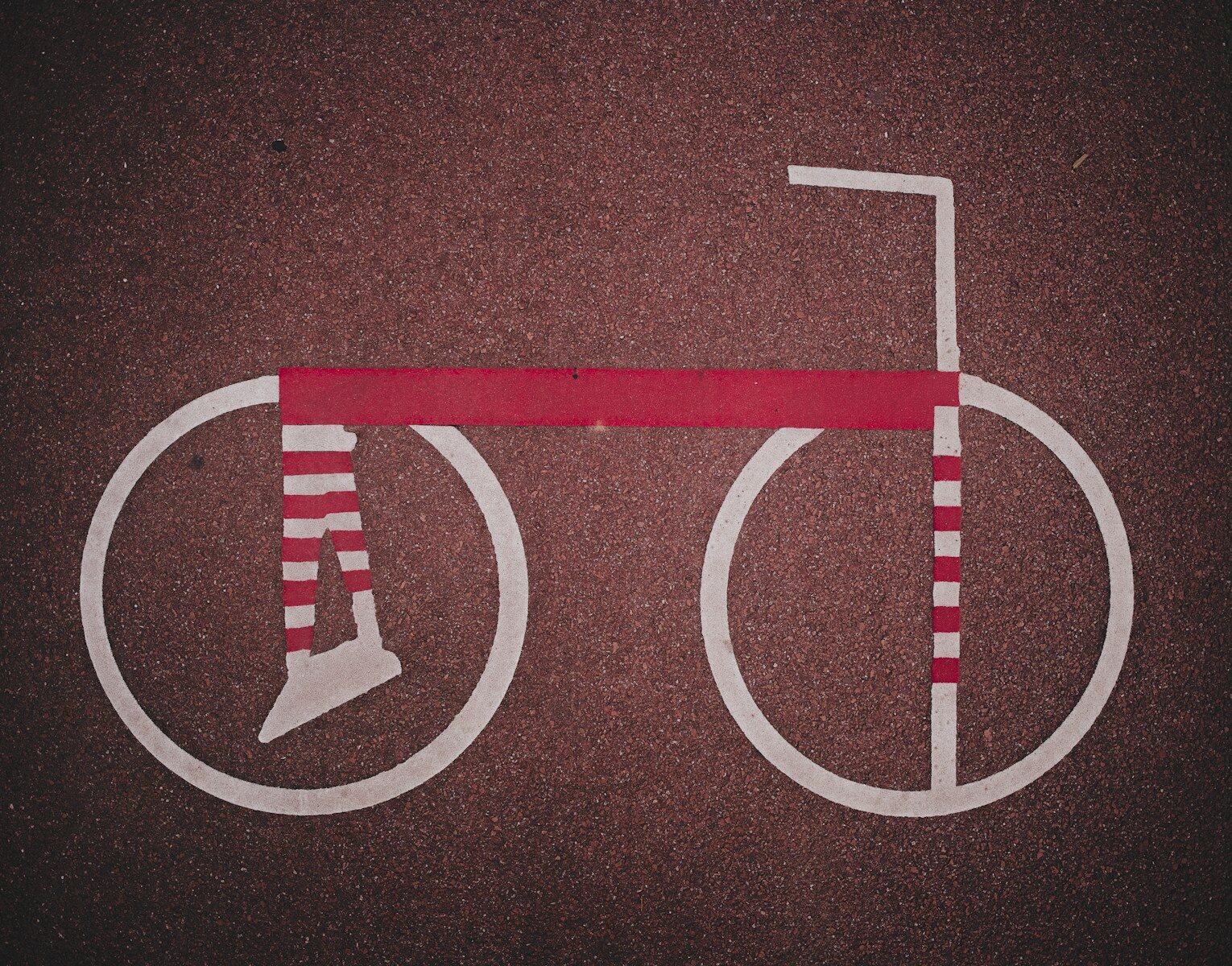 Stylized bicycle with striped wheels and frame.